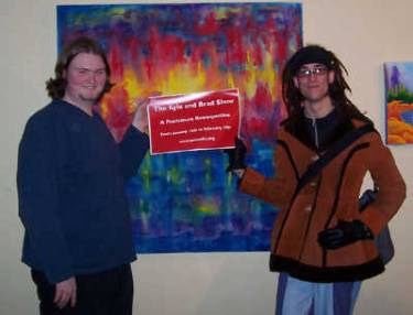 Kyle Clements and Brad Blucher proudly holding the sign for their very first art show.
